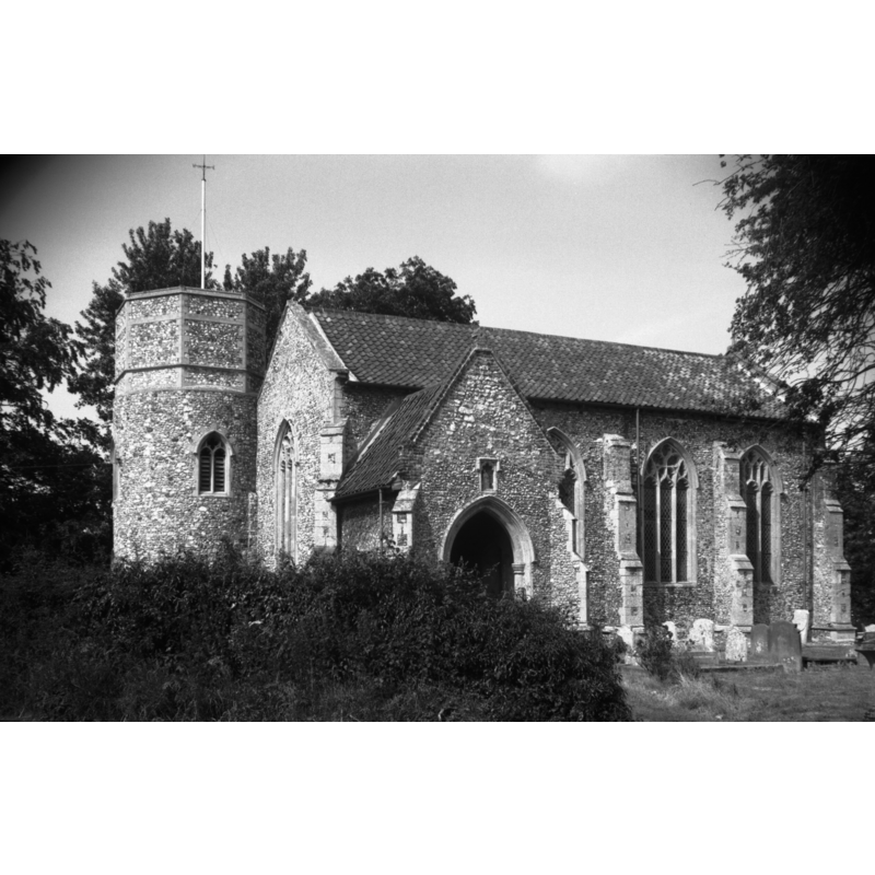 Photo caption: "Norman round tower with later octagonal top. The present north aisle built on the site of the original nave. The new nave probably built mid 14c"