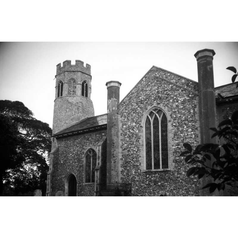 Photo caption: "The tower is circular with early 14c top. The church was largely rebuilt in 1810"