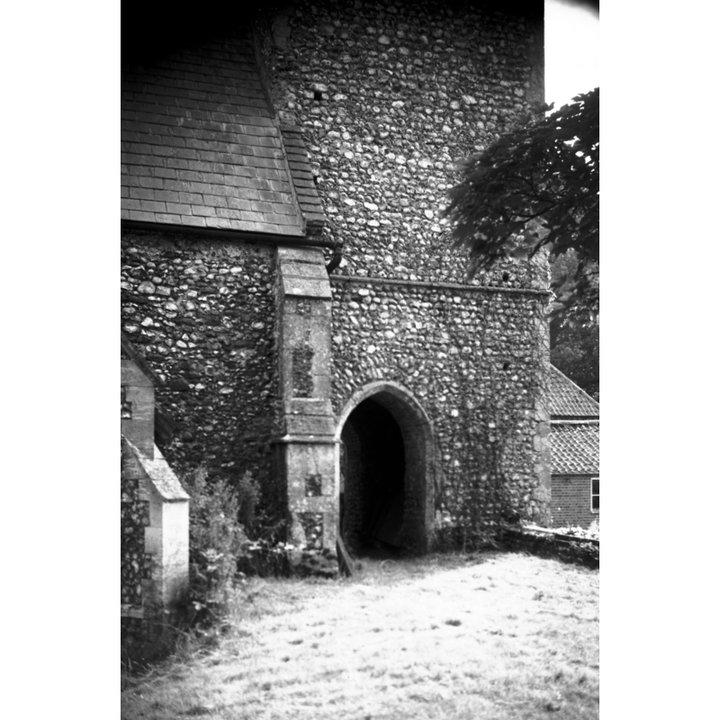 Photo caption: "The tower was built up to the western boundary and to allow processions to pass round the church, arches were placed in the north and south walls"