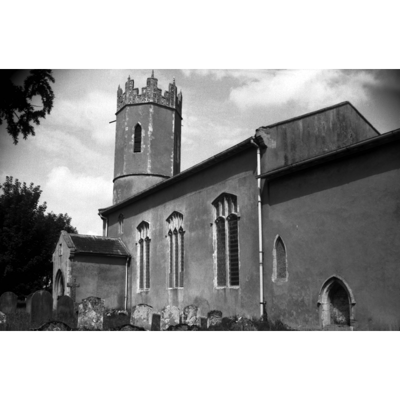 Photo caption: "The church is unfortunately all cemented. The round tower has an octagonal Early English top"