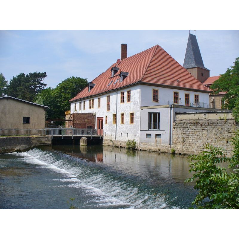 the roof of the tower is visible behind the mill (?)