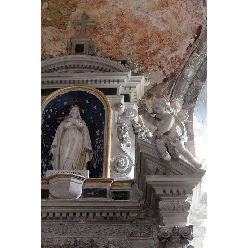 the figure in the central painting is St. Philomena, depicted here with an anchor to her side and a palm (?) branch in her hand [symbols associated with this saint are: anchor, arrow, lance, lily]