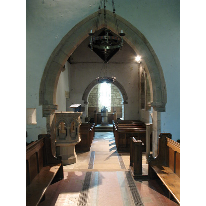 from the chancel; the font and cover are visible at the west end