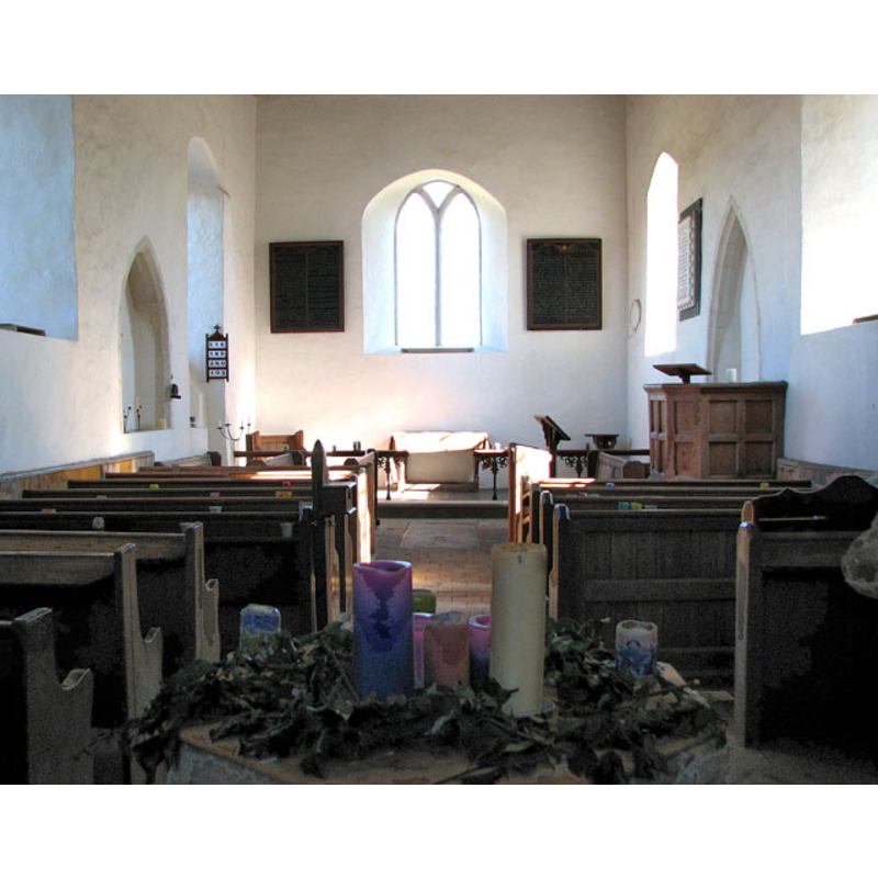 in the foregound, centre, an arrangement of candles nested on top of the font