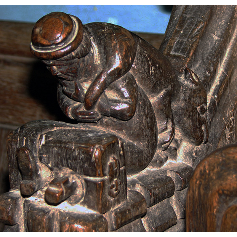 a poacher in the stocks with the evidence of his crime around his neck and down his back