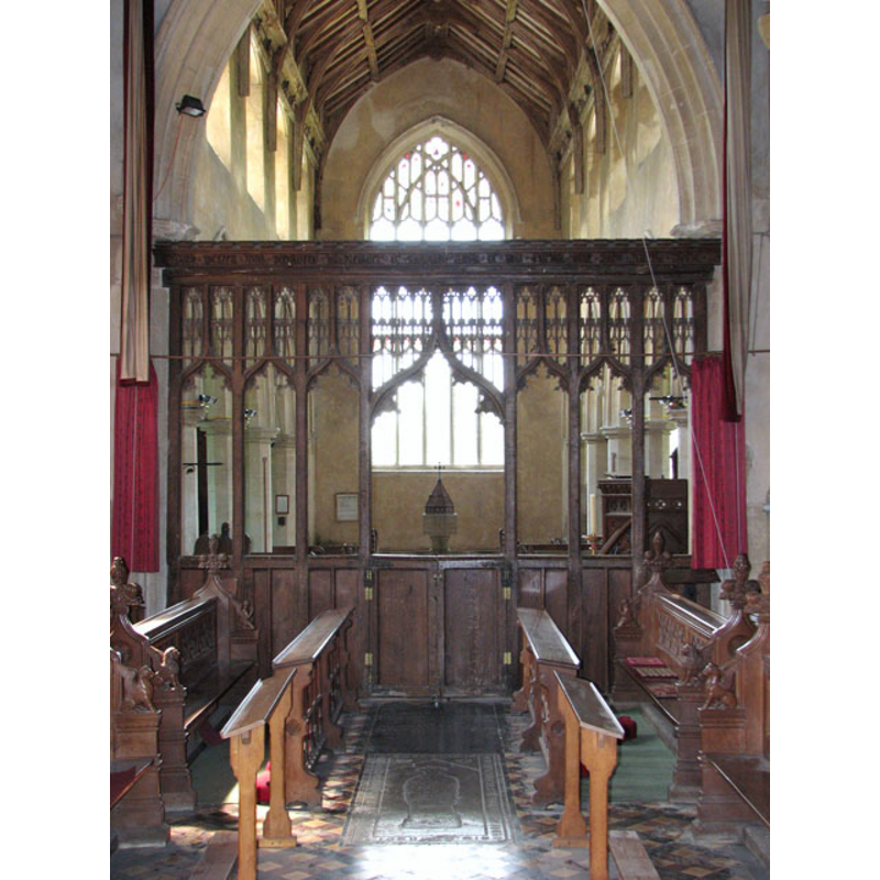 the modern font and cover visible at the west end through the chancel screen