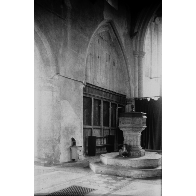 Photo caption: "Screen across west arch of south aisle. Early 17c font"