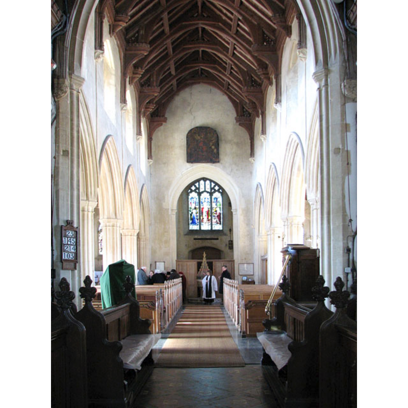 the font is located at the west end, partially hidden here by the vicar standing in front of it
