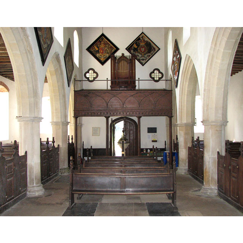 the 18th-century 'bird-bath' font is visible by the west doorway