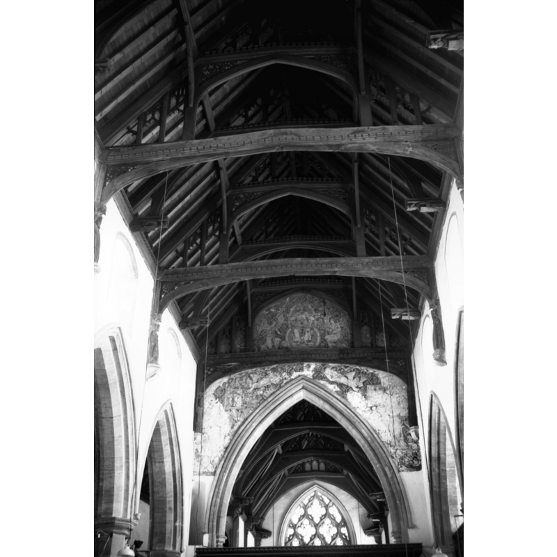 Photo caption: "Tiebeams on arched braces up to the collar beams. Mural painting over chancel arch"