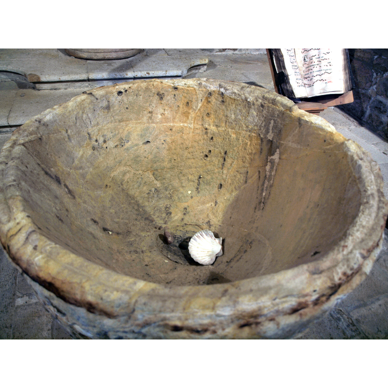 the shape of the inner well suggests a later, Gothic, date, not Romanesque