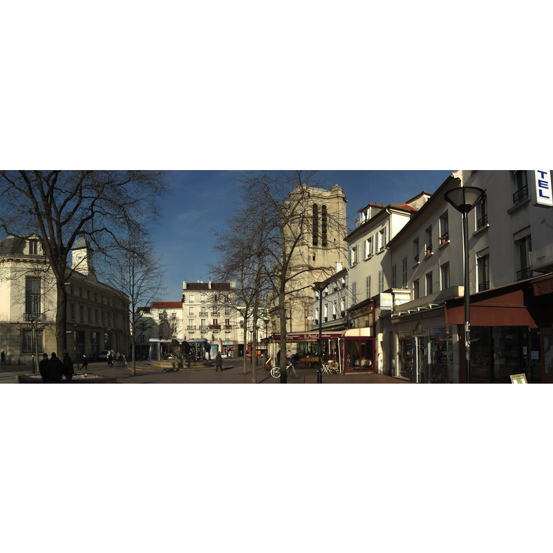 the prominent church tower in the context of the Place de la Mairie
