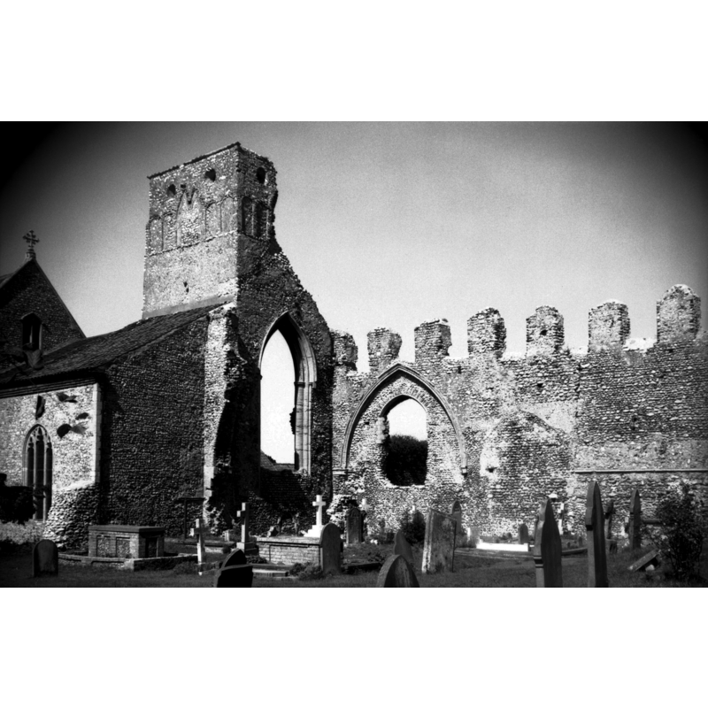 Ruins of the old priory church; the building on the left is part of the parish church