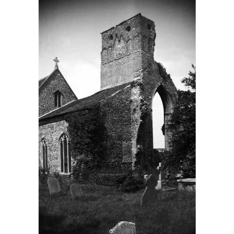 the parish church -- Photo caption: "With ruined priory tower"