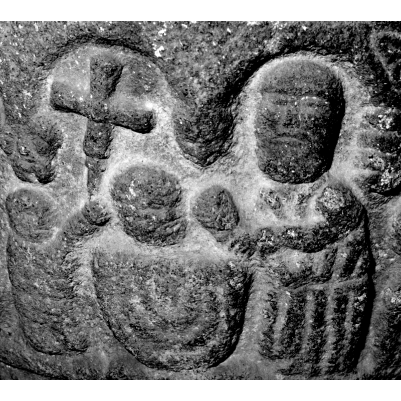 located above the cross-bearing accolite, left side of the baptismal scene; the 'floating' head or mask is directly above the accolite's own head