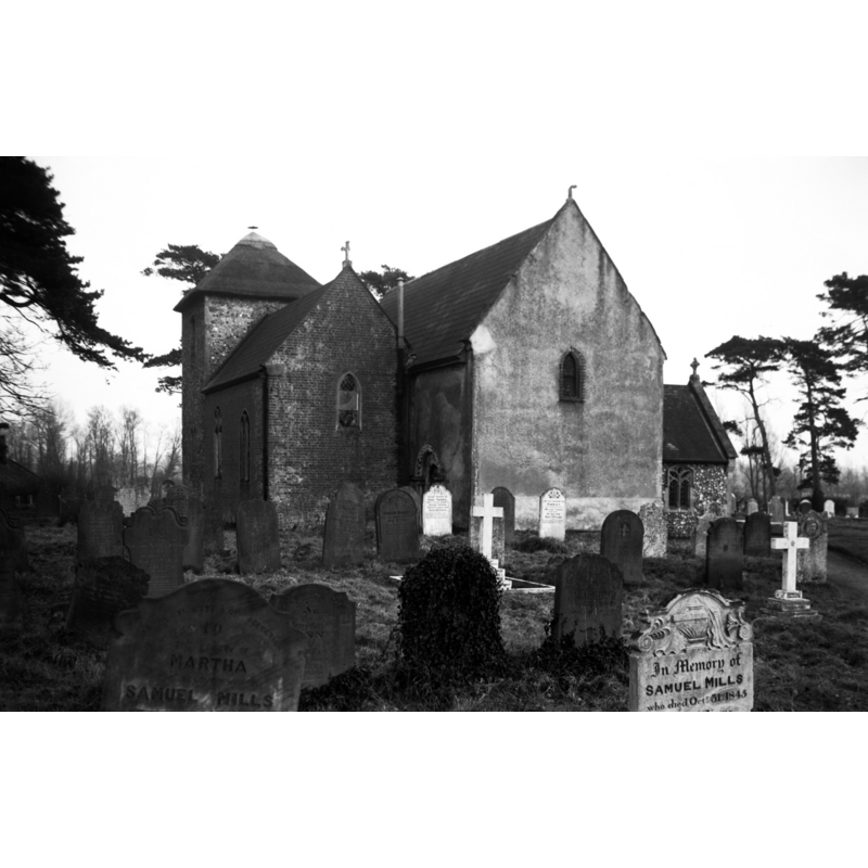 Photo caption: "The square tower, the lower part of which is Norman, is unusually placed on the north side, with east wall flush with the east wall of chancel"