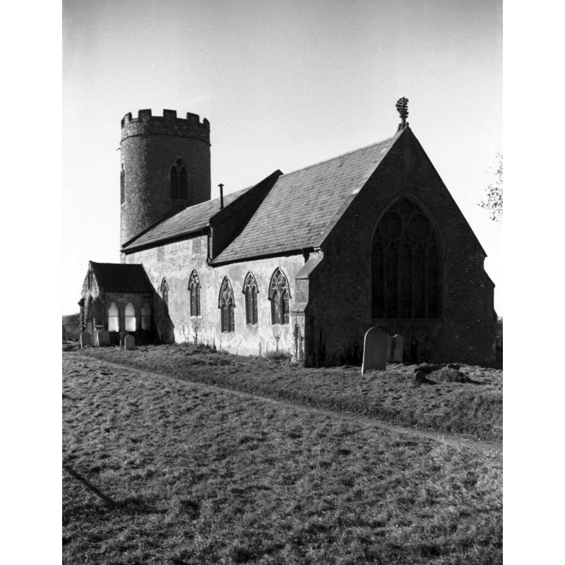Photo caption: "Norman round tower. 14c windows. Ancient gable cross"