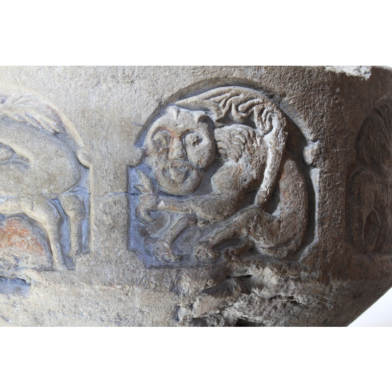 tentatively identified mainly from the mane and the acanthus-like tail; seated in an odd position; the tongue appears to be sticking out -- on the southeast side of the basin [NB: orientation is approximate] -- identified as the Devil in one of the sources ["abelignende Satan [...] der skildres som en tungerækkende abe, måske fordi han ville efterabe Guds skaberværk"]