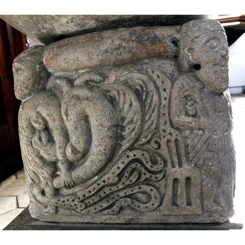 the three elements in the body of this snake can be discerned here: 1)a smooth thick part with the head attached to the left breast of Luxuria, its tail held by Luxuria's left hand; on the top curve of the reptile's body two small feet; 2)two feathered or plumed parts to the right of the thick snake body; 3)a beaded-tape prolongation of the snake's body that intertwines on the lower area; here the back-rest of the monk's chair on the right is not part of the snake's body -- on the north side of the base [NB: orientation is approximate]