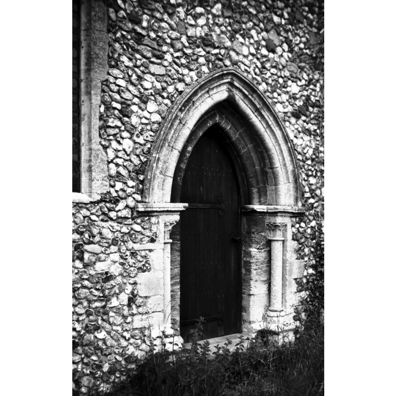 Photo caption: "Late Norman priest's door on south side of chancel"