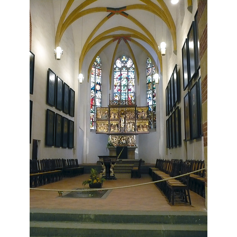 Photo caption: "Altar of Thomaskirche in Leipzig, Bach's grave can be seen in the floor" -- the 17th-century baptismal font is located between the altar and Bach's tomb -- the altar was originally from the now demolished Paulinerkirche of Leipzig