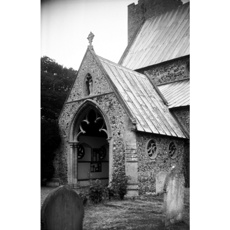 Photo caption: "The side windows circular with mouchette wheels"