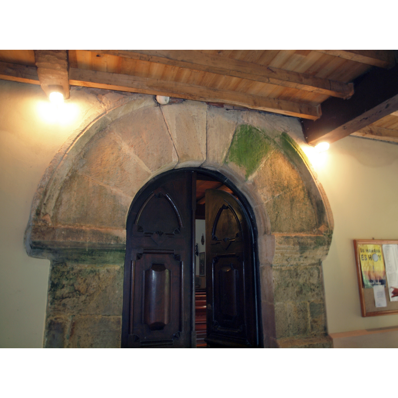 the original west portal is enclosed in a porch that provides access to the cemetery via another door