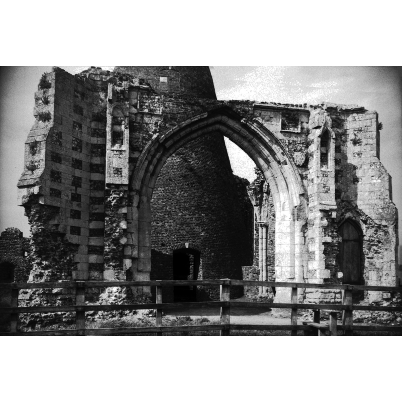 The ruins of the abbey gatehouse in August 1978 -- Photo caption: "An abbey of Benedictine monks founded here in 1020 by King Canute on a site previously occupied as early as the year 800 AD by a society of Saxon monks. In 1535, by virtue of a private Act of Parliament, the revenues of this abbey were exchanged for those of the old estates of the See of Norwich. The abbey was united to the Bishopric, and the bishops of Norwich became from that time, and still remain, Abbots of St Benet's-at-Holm"