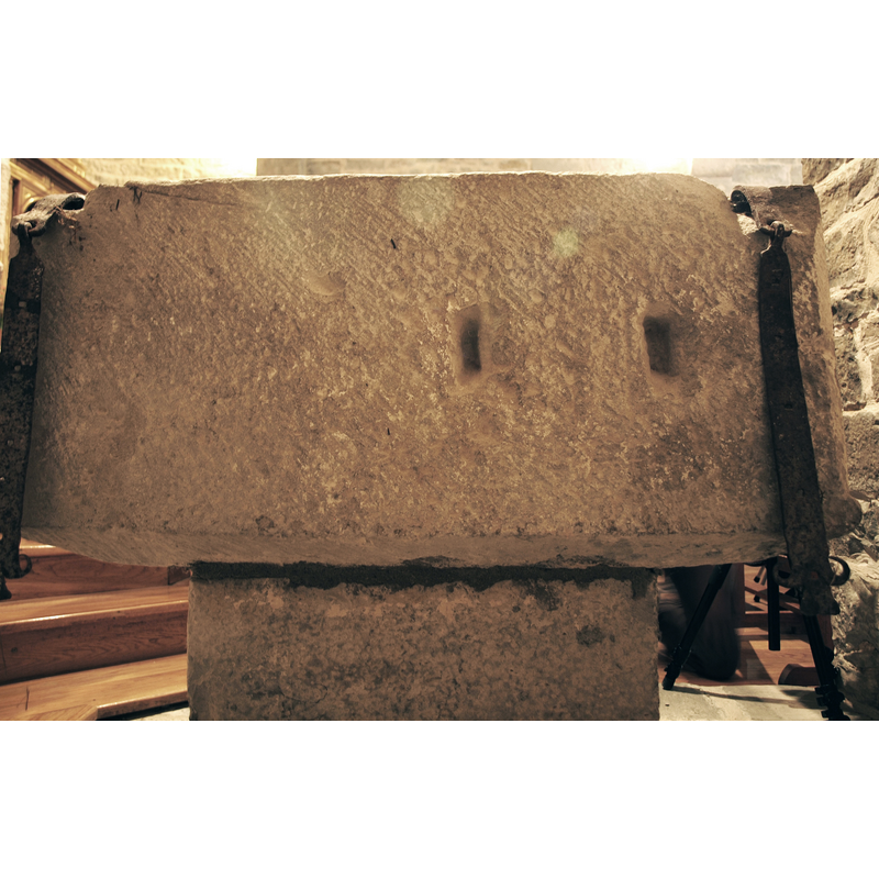 this is the side facing the back wall of the 'baptistery'; the two indentations may have been made to anchor cover hardware -- notice the two hanging metal bars, at left and right, which are part of the cover locking hardware