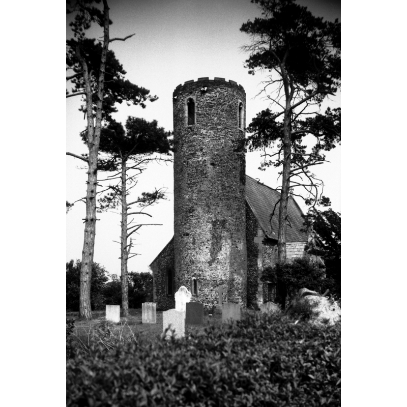 Photo caption: "Round tower probably Norman but with later brick top"