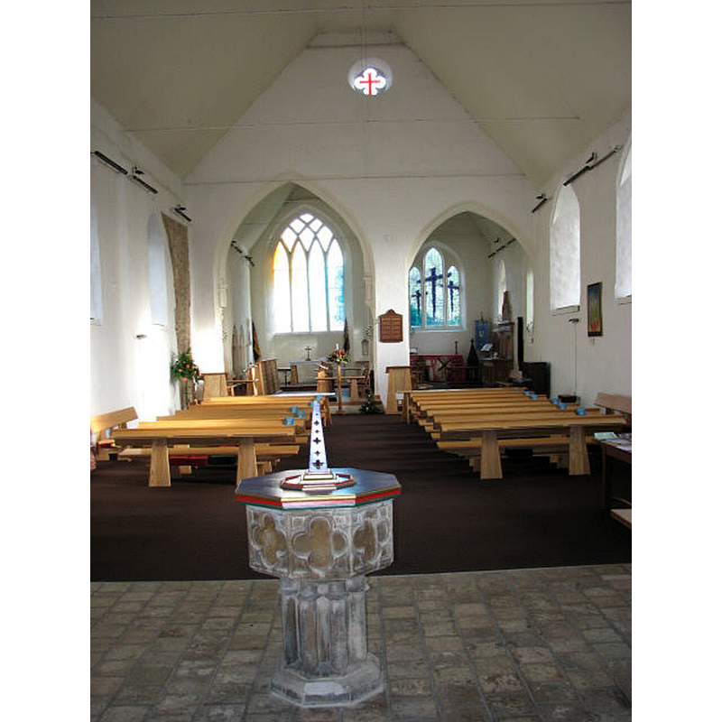 the interior of the reconstructed church after the 1981 fire; the font seen here was originally at the church of St. Miles Coslany, Norwich -- Photo caption: "On 19th March 1981 the church was gutted by fire during ongoing restoration work on the church tower, leaving only the tower and the curtain walls. Most of the interior, including memorials and font, were destroyed. The present furniture was designed and made in 2000 by John Barnard. The stained glass windows were designed by Sarah Bristow of Norwich in 1999/2000. The tower was built in 1447. It contains 6 bells, the tenor dating from 1261. This church is open every day"