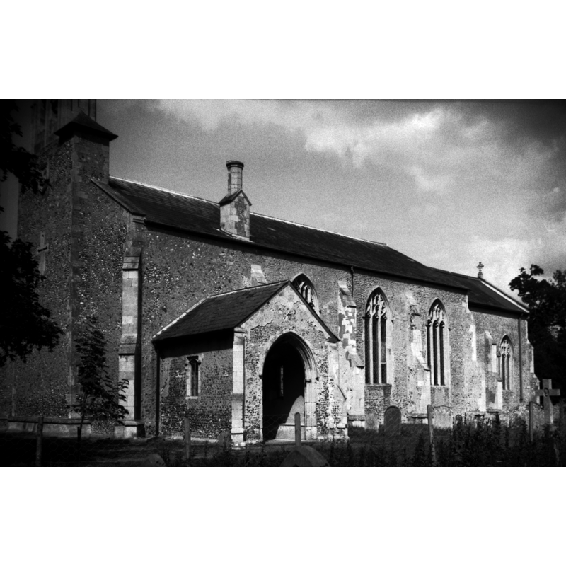 Photo caption: "The tower fell in 1677. The chancel has only a bellcote, put up on a broad buttress in 1902"