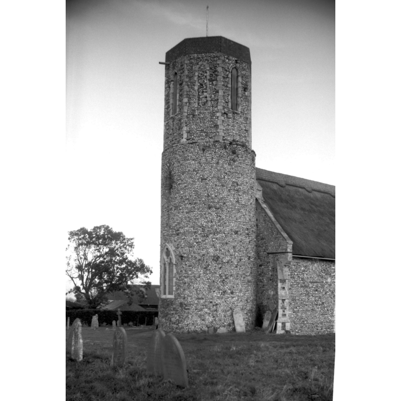 Photo caption: "Norman round tower with 14c top"