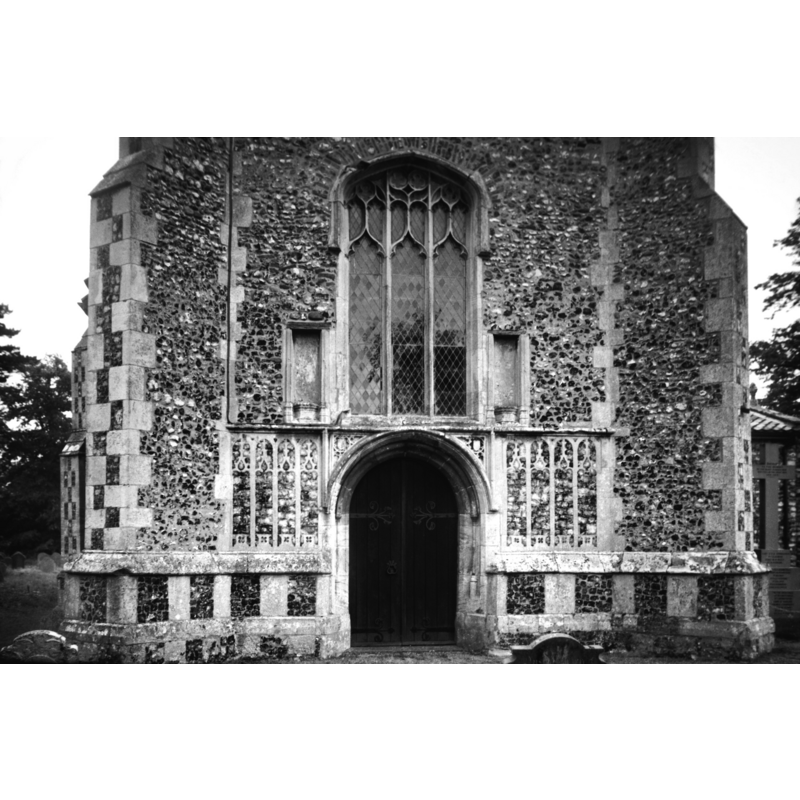 Photo caption: "West window and doorway with niches and flushwork panelling 15c"