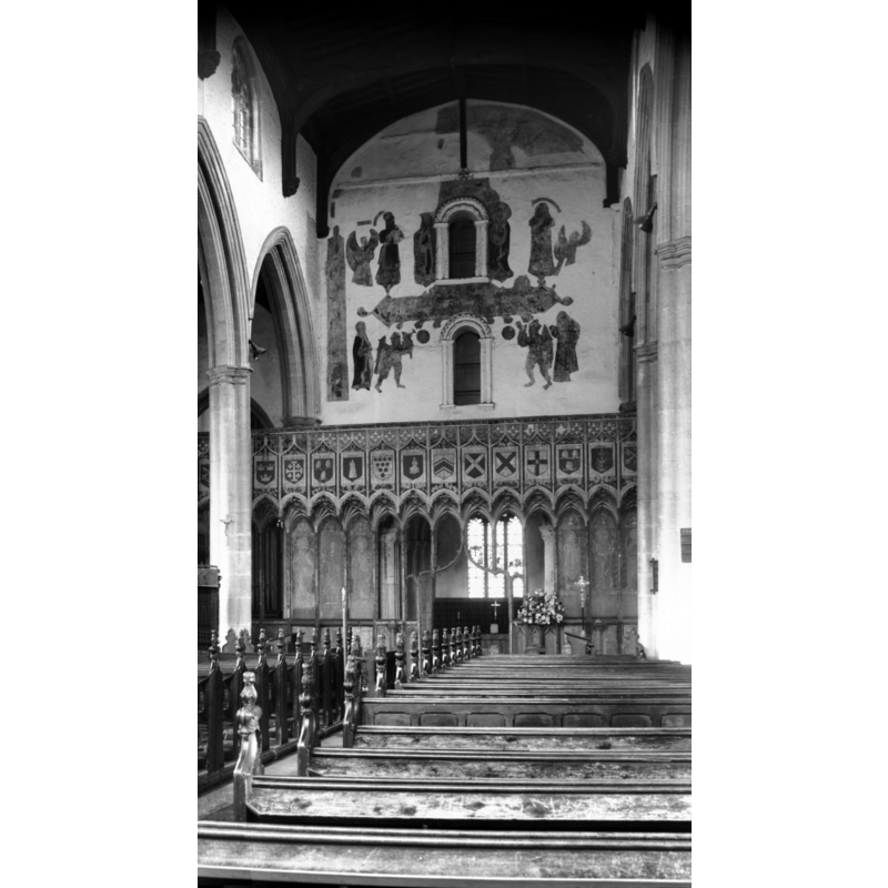 Photo caption: "Two Norman windows above screen, and supporting paintings to the rood"