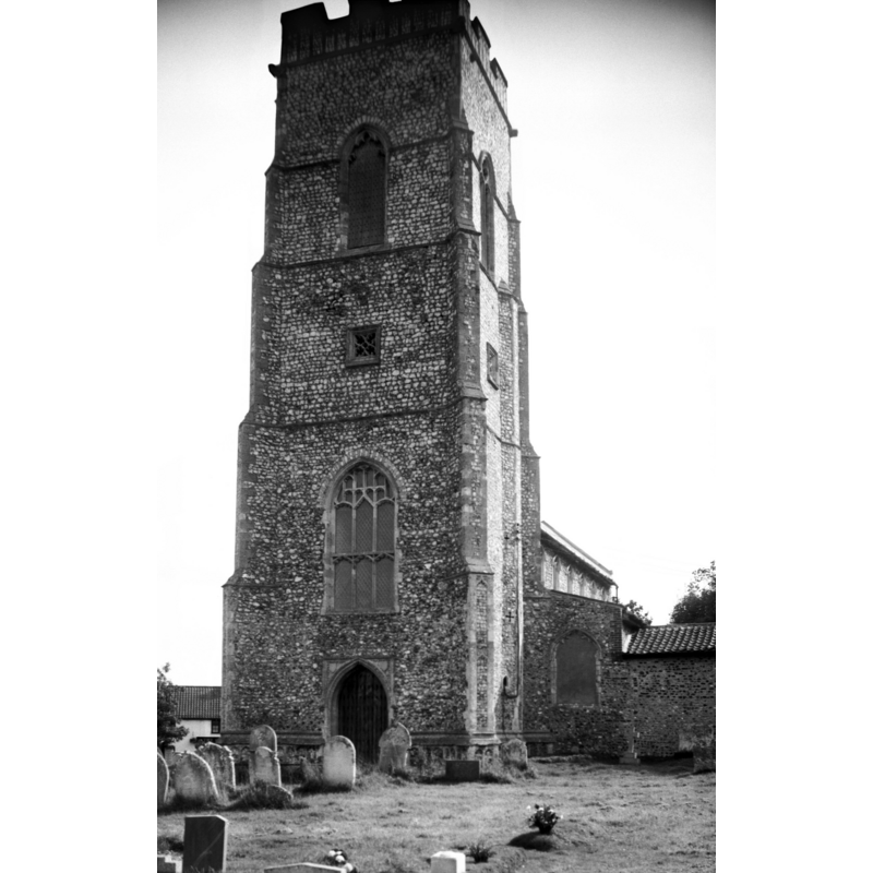 Photo caption: "15c with stone panelled base course, traceried sound-holes and a good parapet"