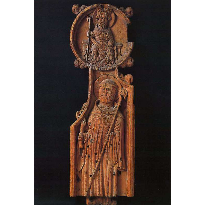 Side of one of the old [15thC?] bench ends formerly from this church, now at the Føroya Fornminnissavn [National Museum of the Faroe Islands]. The museum caption title below appears to identify St. Olav, inside the upper circle, and Abbot Brendanus [aka St. Brendan, aboot of Birr, aka Brendanus Biorra] below -- Photo caption: "Pultavangi P. Uttan sæst Ólavur Heilagi yvir abbatahalgimenninum Brendanus. Innan tær tríggjar krúnurnar hjá norðurlendsku uniónini og ein skjøldur við einum veðri – Føroya vápin." [visit the Føroya Fornminnissavn site [http://savn.fo/00053/00472/00520/00276/] [accessed 21 June 2014] for the rest of the listed and illustrated bench ends of this church].