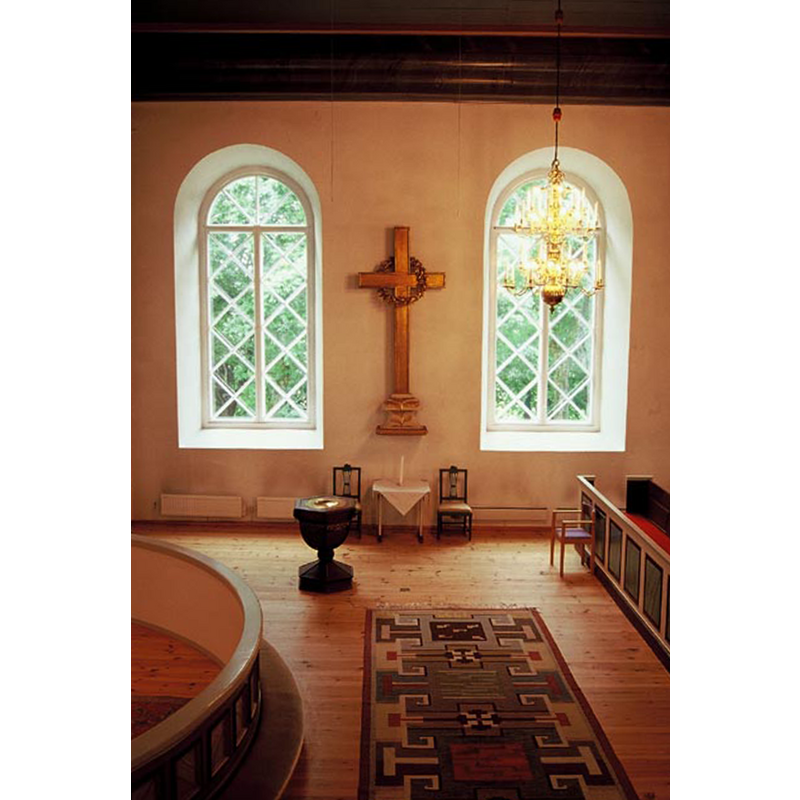 in the southeast corner of the nave; the curved communion railing is partially visible on the left