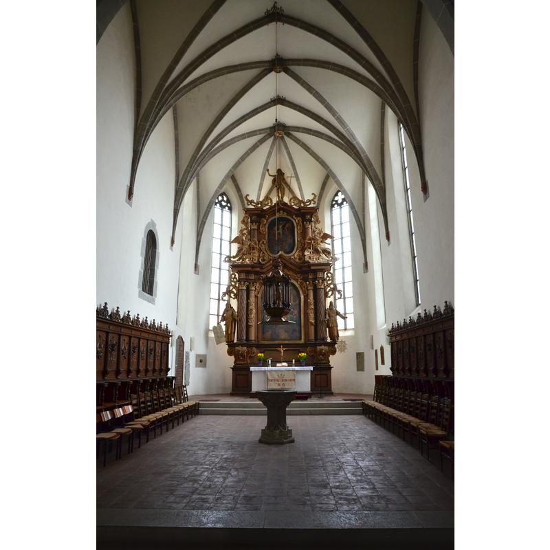 with the font and its suspended cover in the centre of the chancel