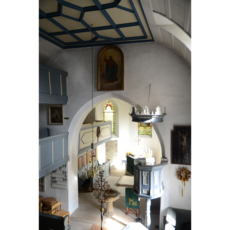 the modern font, beneath the chancel arch