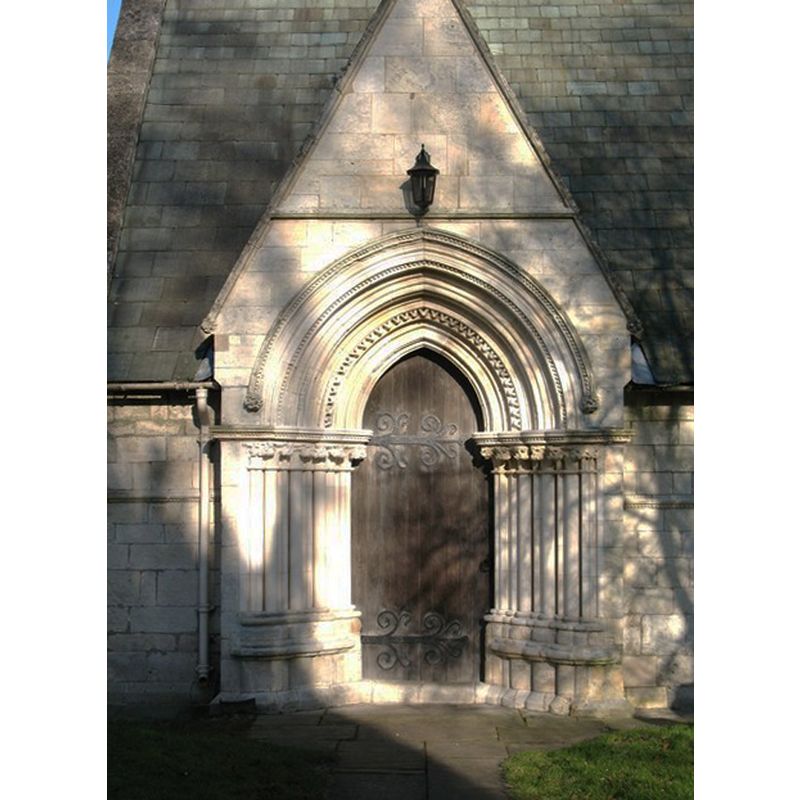 Photo caption: "The south doorway displays some beautifully carved stonework [with some recent restoration and replacement]."