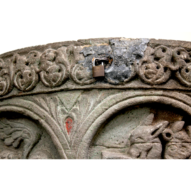 a modern padlock to lock the modern cover in place has been brutally fitted in the area that was originally damaged by an old staple; located above the spandrel between the Annunciation (left) and the Nativity (right)