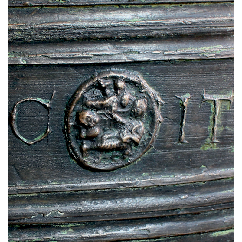 a medallion showing the two animal heads above the manger at the top; below is Mary facing left her right hand raised towards the Child Christ; a very large head on the left may be Joseph