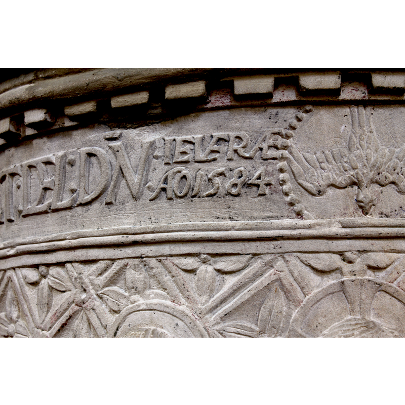 the date the font was re-carved?  next to the dove that tops the scene of the Baptism of Christ