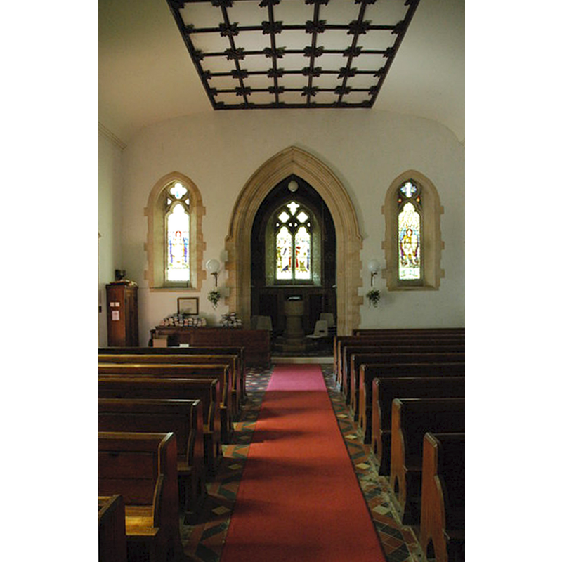 with the font at the far [west] end, beneath the tower