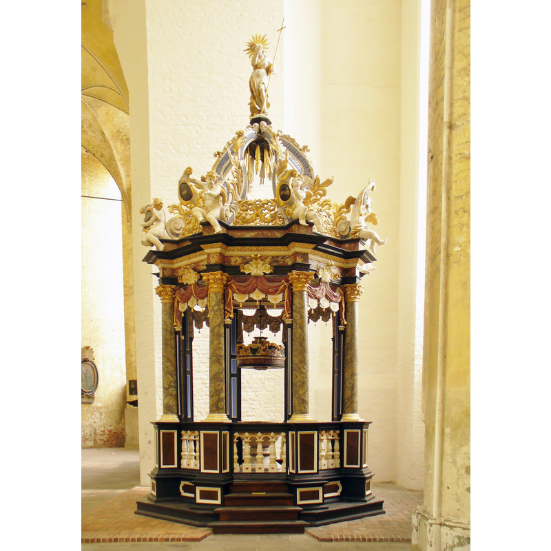 the font hardly discernible inside the Baroque canopy