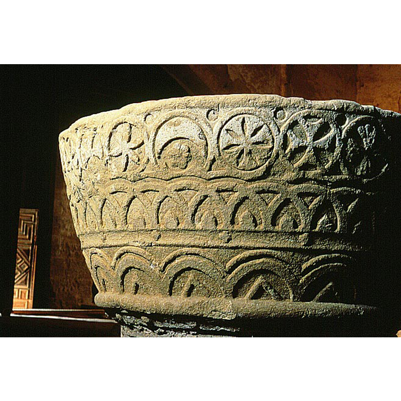 tiny ones, in the spandrels created by the encircled motifs of the upper register