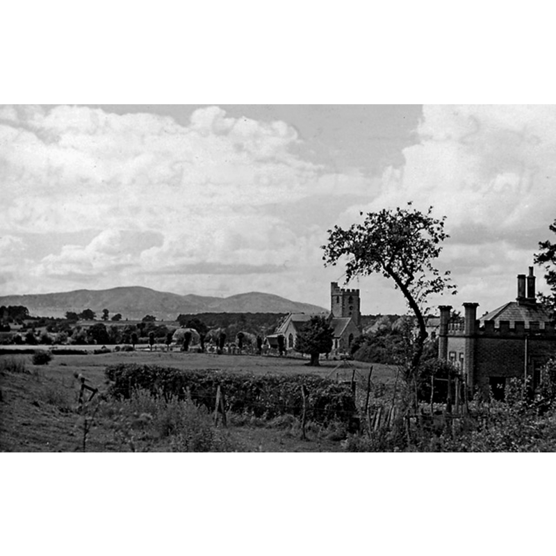 Source caption: "Westward to Malvern Hills (Worcestershire Beacon and North Hill) from A38 at Severn Stoke. Village church centre right."