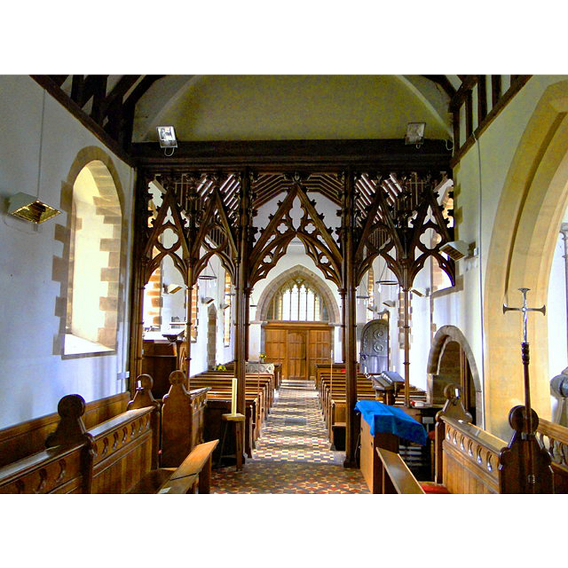 Source caption: "The interior is a surprise after the Norman and 13th century exterior. A complete set of Henry Woodyer fittings survive, including screen, pews, font and pulpit, all installed as part of a 'restoration' of 1861-2." -- the modern font is partly visible at the back [west], on the left [south] side
