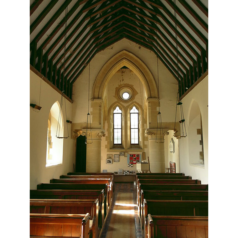 the modern font and cover are visible at the far [west] end of the nave in the new church of St. Mary